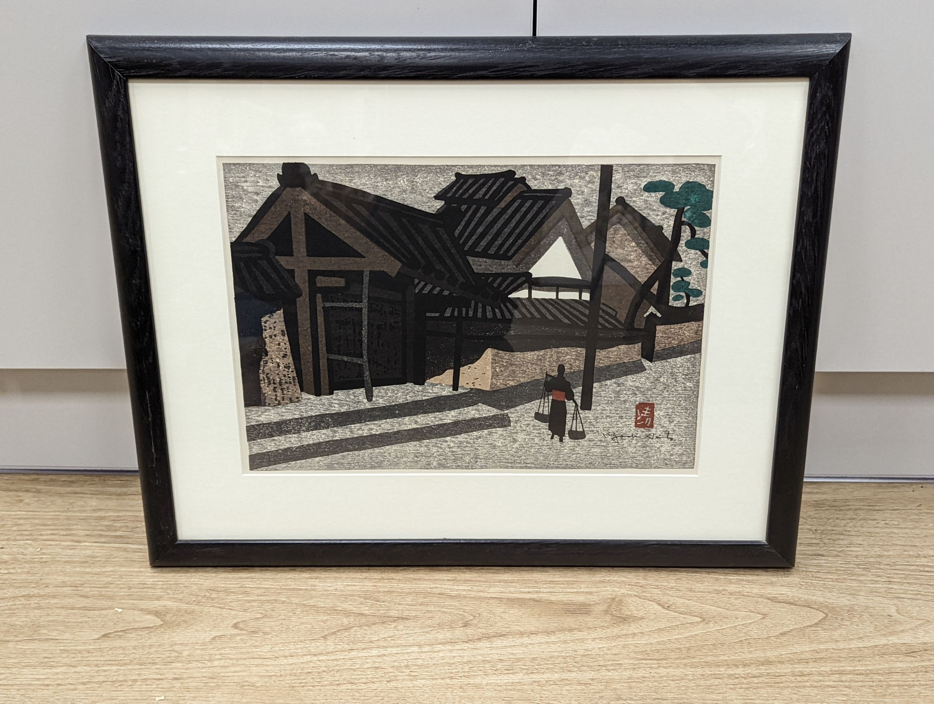 Kiyoshi Saito (1907-1997), woodblock print, Figure passing houses, 27 x 39cm
